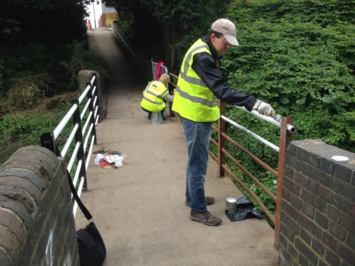 Volunteers painting the footbridge over the canal in August 2015